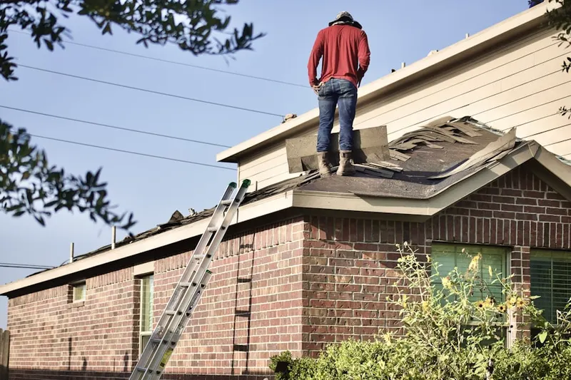 Professional roofer working on a residential roof in Barnesboro